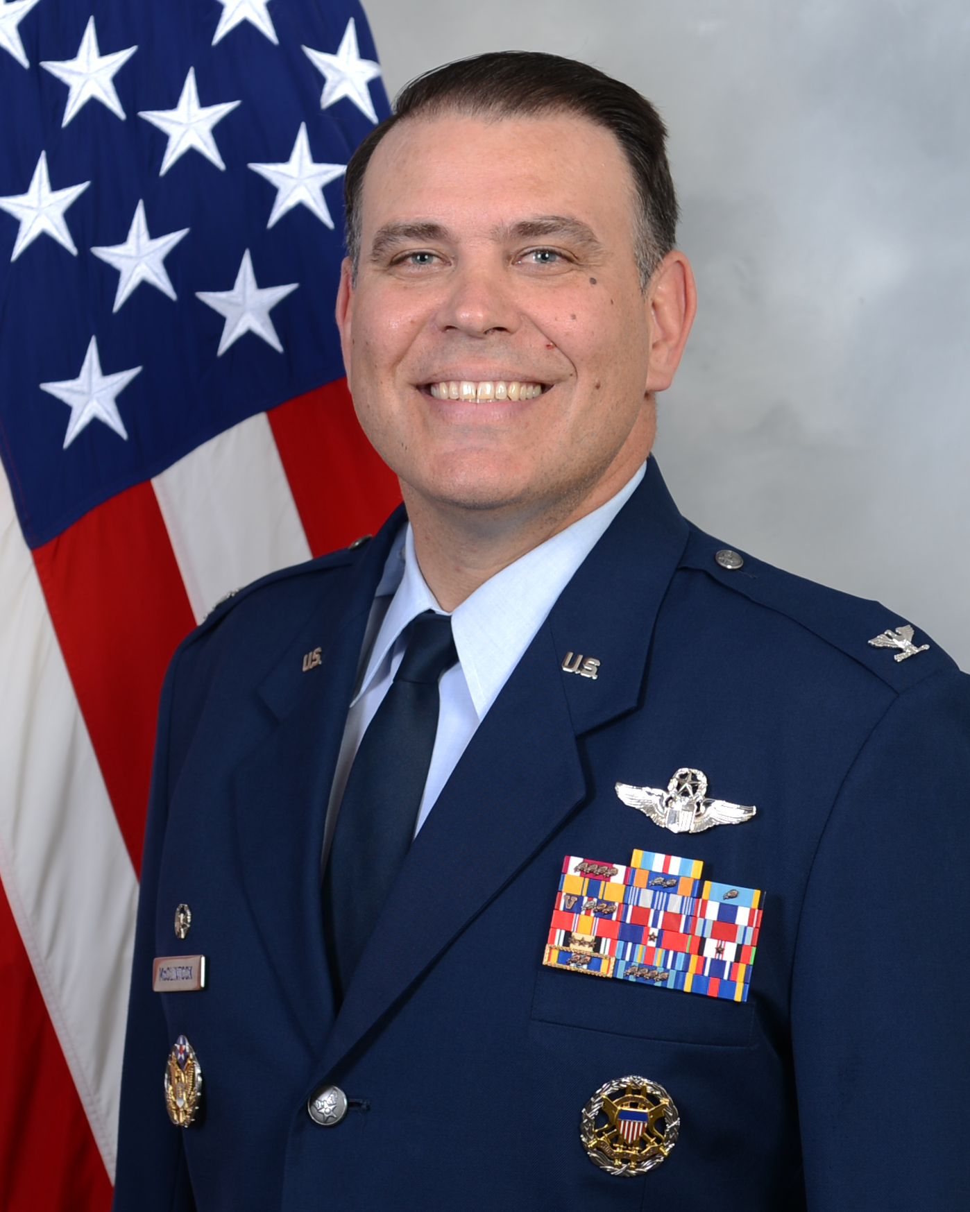 62 OG Commander official photo with American flag background